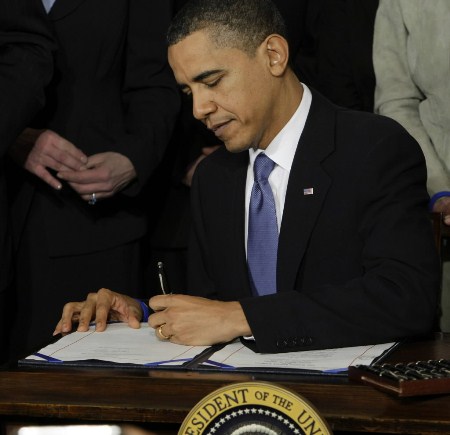Obama signs the healthcare legislation into law