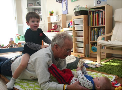 Description: Jack is bouncing on my back while Owen shows me his giraffe.