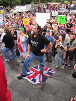 BP Protester stand on the Union Jack