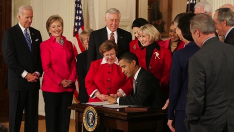 The president signing the Lilly Ledbetter Fair Pay Act