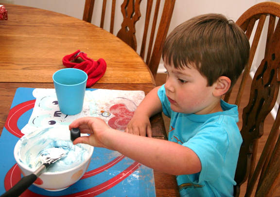 Then Jack added the blue food coloring to the white icing.