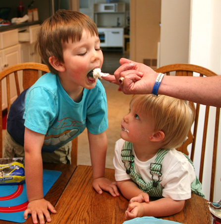 While Jack tastes, Owen looks on inquisitively.