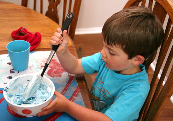 Then Jack blends coloring into the icing.