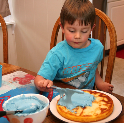 Jack begins the icing process. 