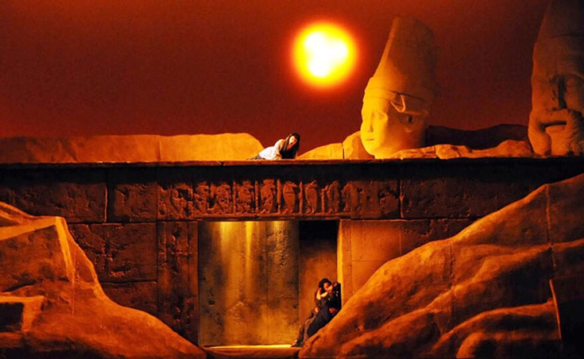 Three lovers: Amneris alone outside the tomb and Radames and Aida inside the tomb.