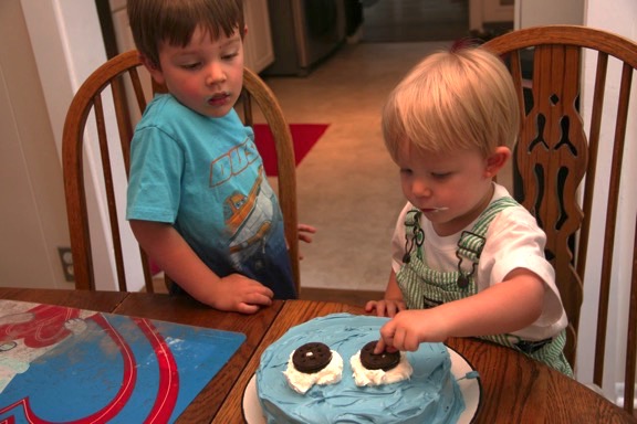 Owen and Jack are finishing their father's birthday cake.