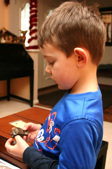 Jack looking at a fossil