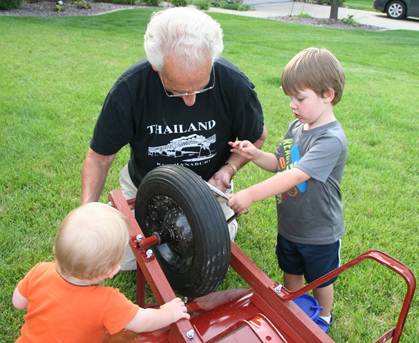 Al with the boys looking at a wheelbarrow